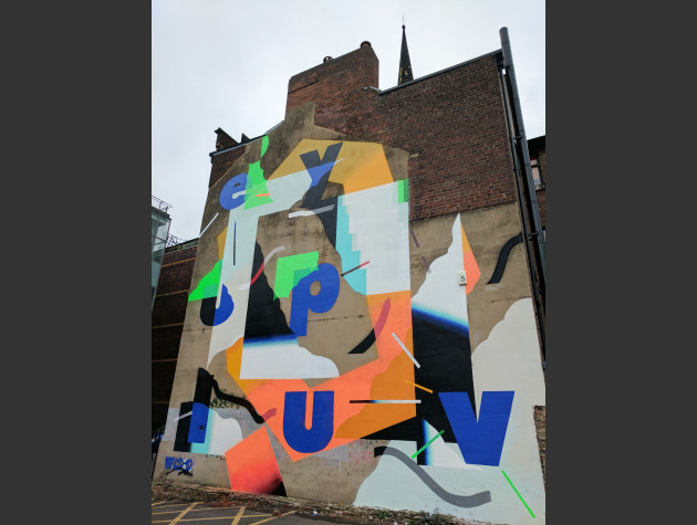 Abstract wall mural featuring the expression ey up luv